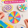 Deux enfants fabriquent un spinner en papier coloré